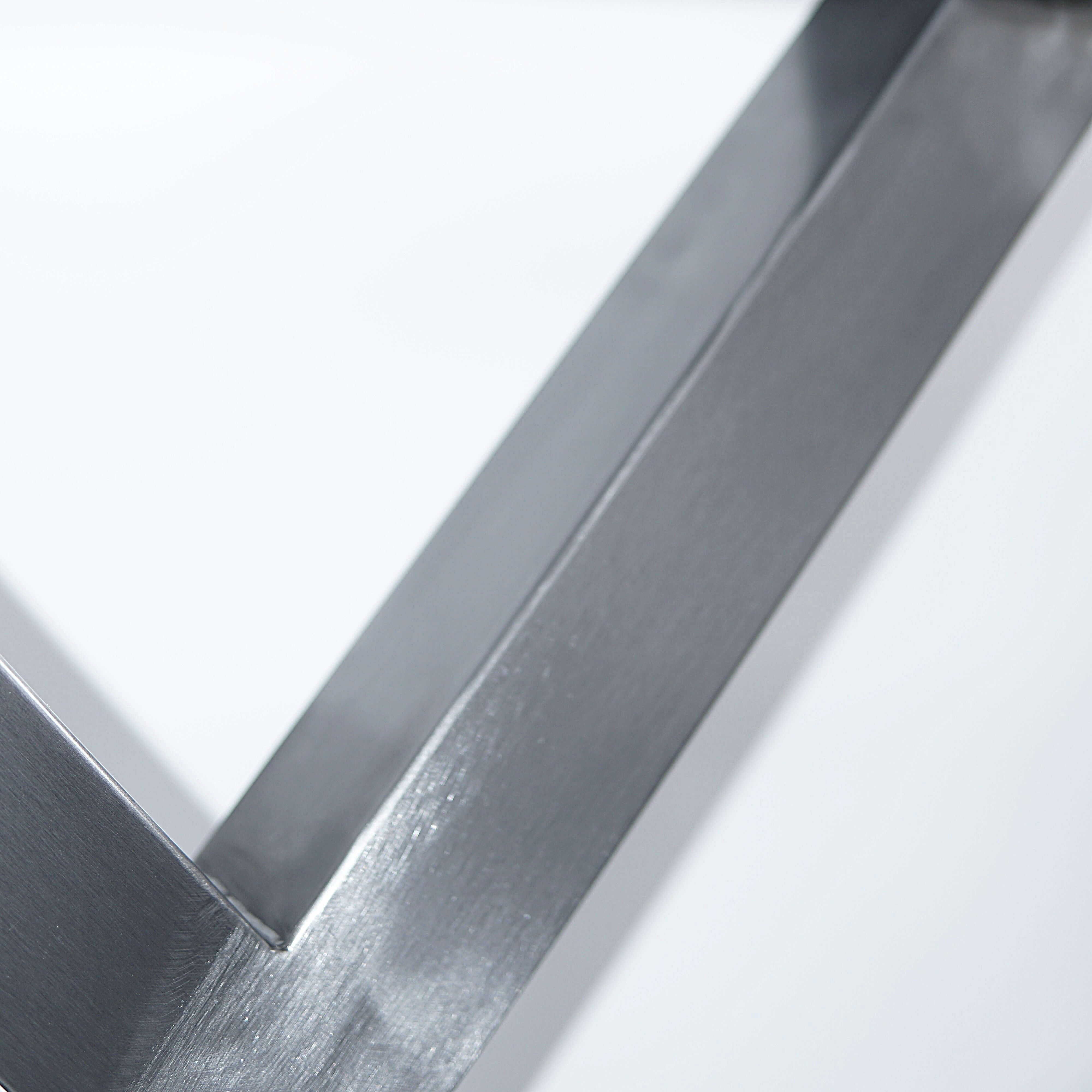 Silver bench X-leg cross brace with smooth welded metal edges and mounting contact.