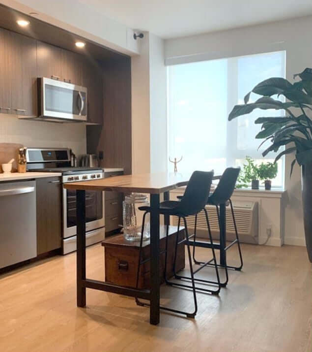 Rectangular dining table with light wood surface and dark metal legs