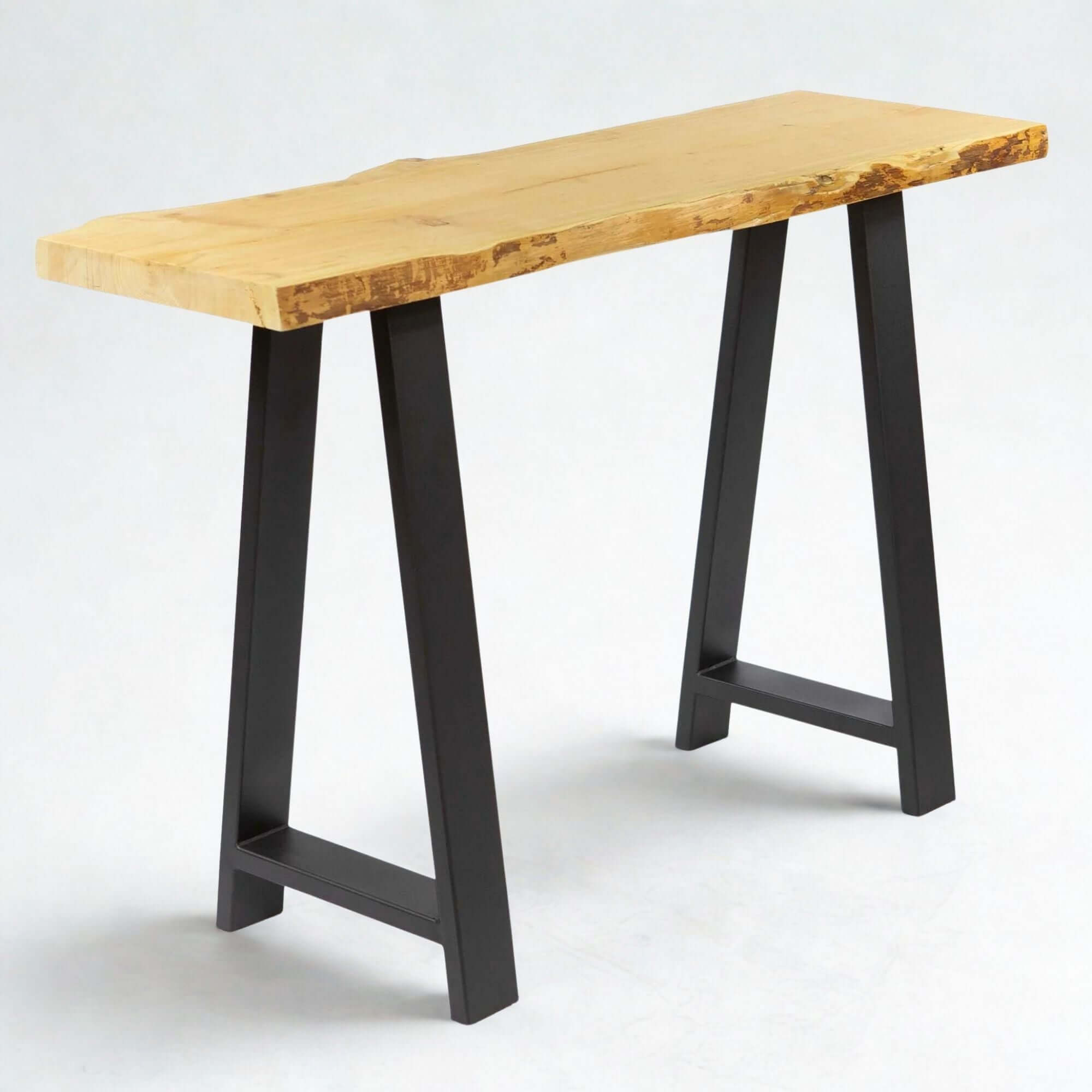 Console table with light wood top and black A-frame legs