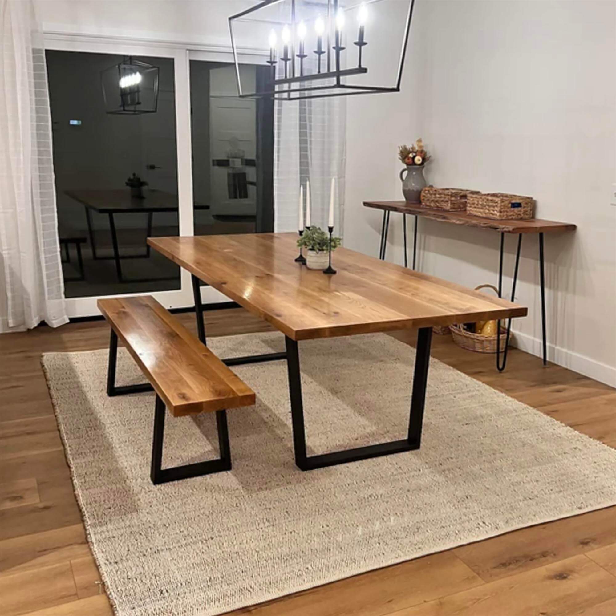 Wood bench top on black trapezoid metal legs with open frame base
