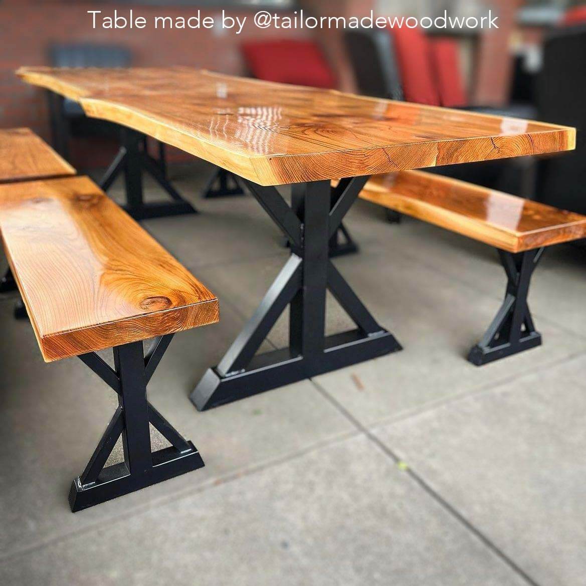 Bench trestle legs with dark steel base and attached arched supports under a wooden top