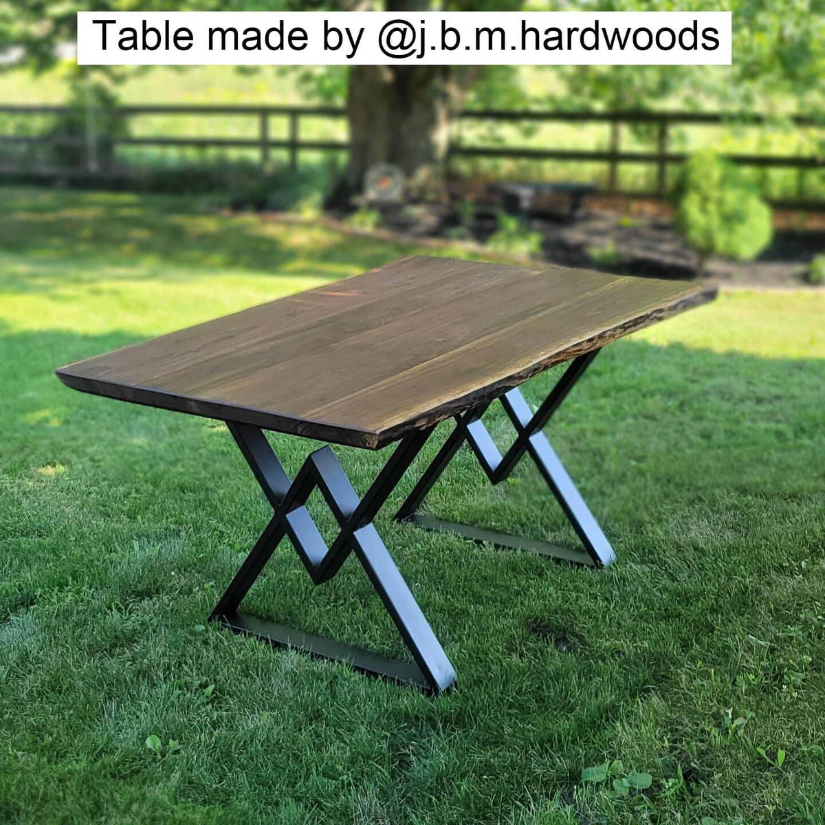 Black metal table legs with diamond cross brace, under a wood tabletop