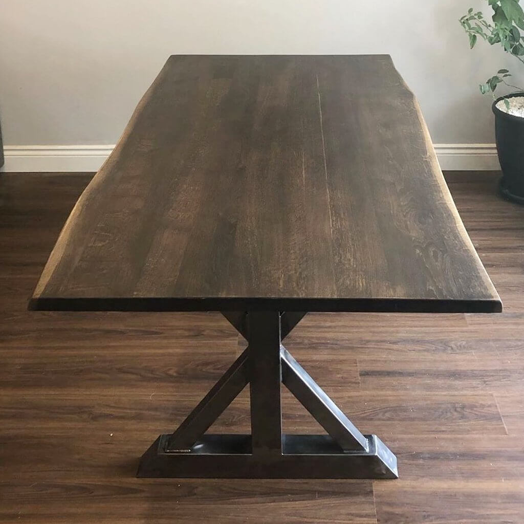 Trestle bench leg base with dark steel X-braced frame and wide square feet