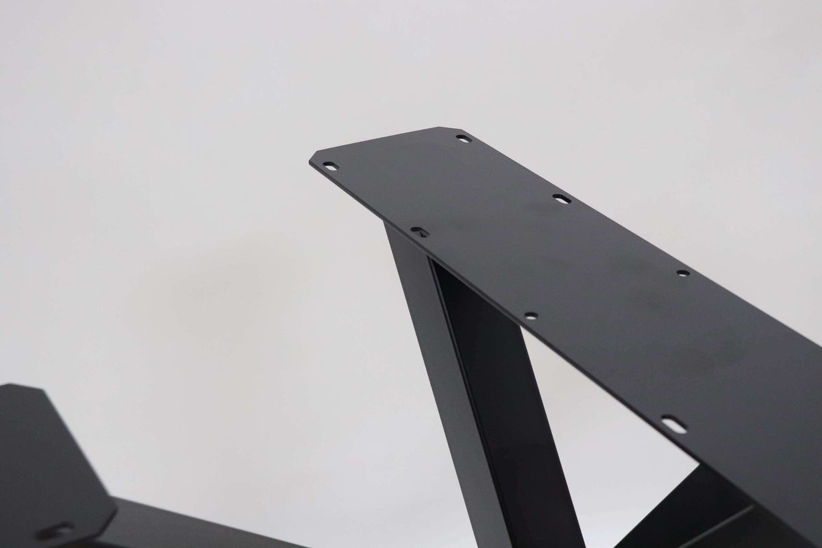 Close-up of dark metal support arm and mounting plate with drilled holes