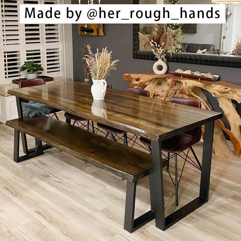 Wood bench/table top supported by black trapezoid metal legs