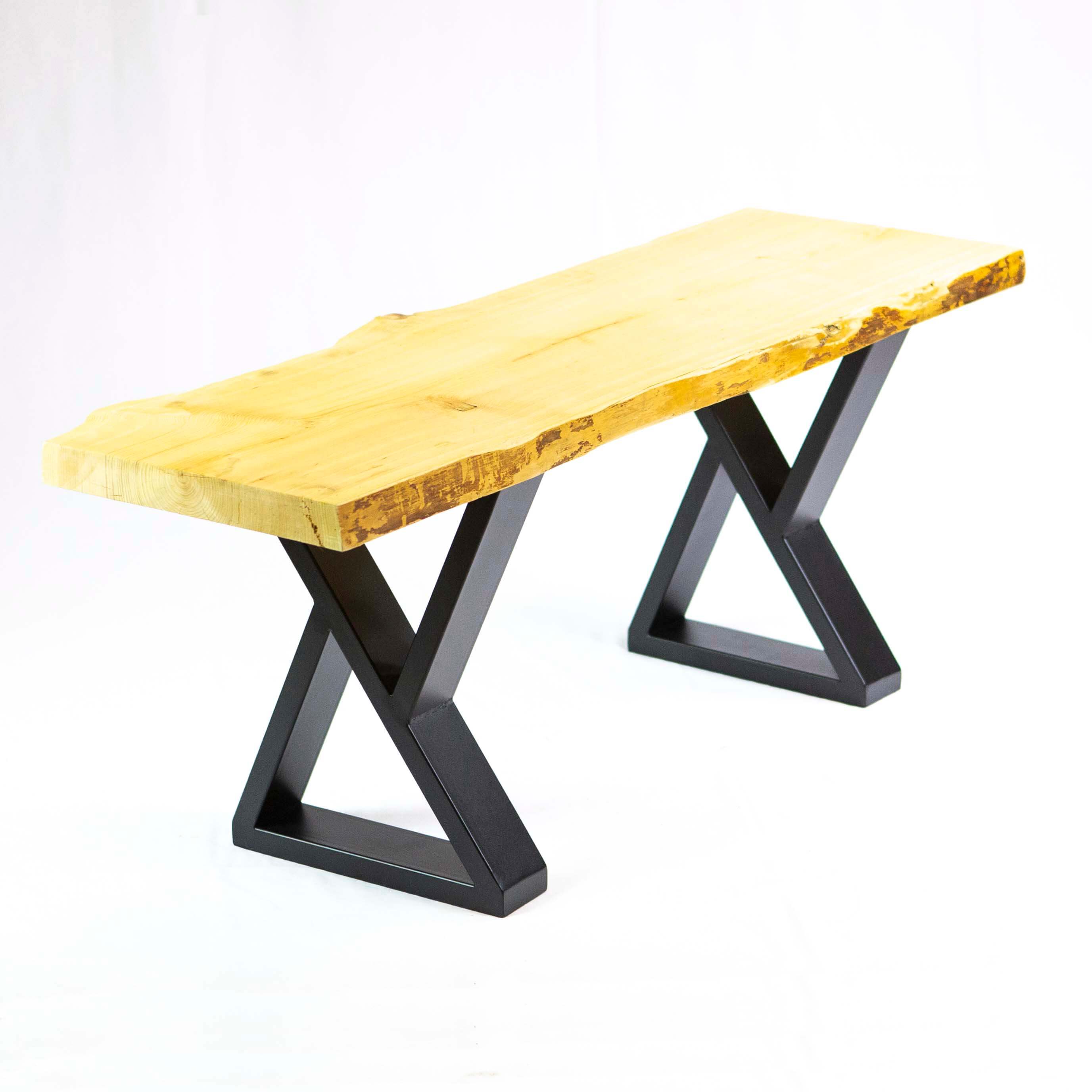 Black Z-shape bench legs supporting a light wood bench top