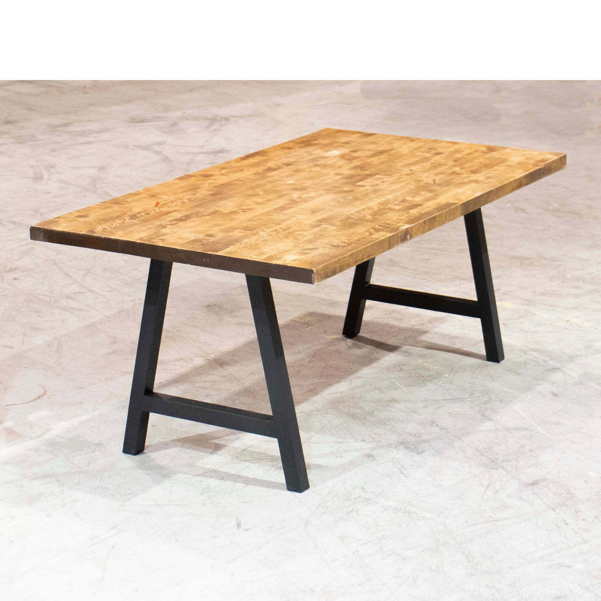 Wooden dining table with black A-frame legs and rectangular tabletop