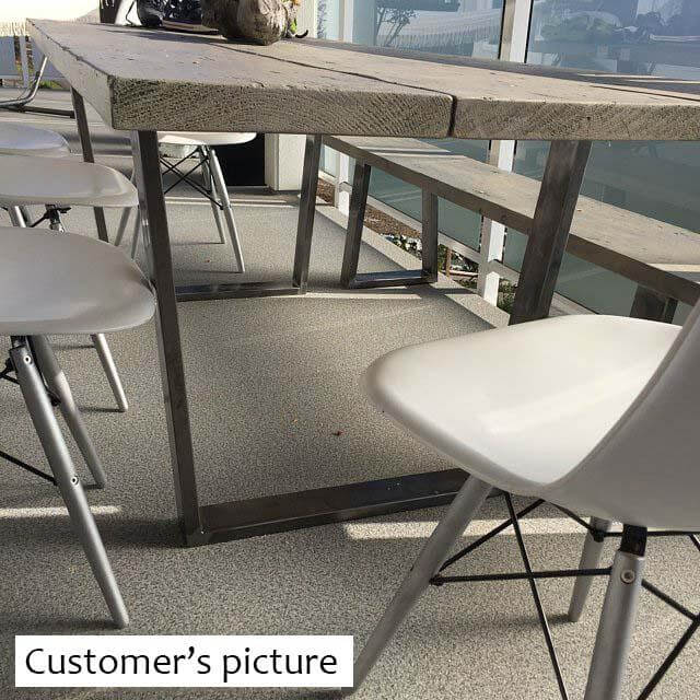 Trapezoid dining table leg frame with wide top, dark metal finish under wood top